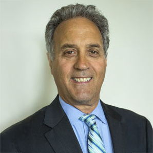 Peter J. Landis, Attorney at Landis Arn & Jaynes. A man with salt and pepper hair wearing a dark blue suit with a light blue shirt and tie smiles at the camera.