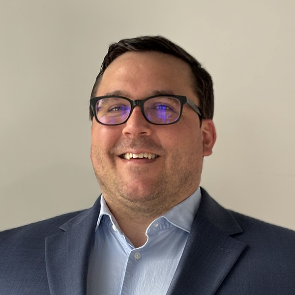 Daniel J. Katyl, attorney at Landis Arn and Jaynes. A man with dark hair, dark rimmed glasses and a dark gray suit jacket with a light blue collared shirt smiles.